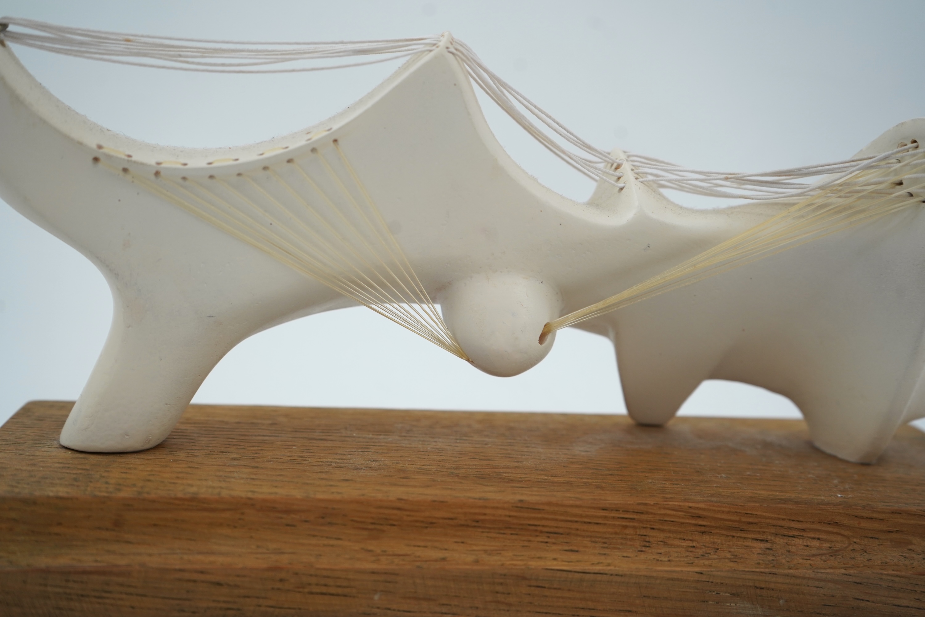Follower of Henry Moore (1898-1986) A modernist stringed plaster sculpture raised on an oak rectangular plinth base, 25cm wide